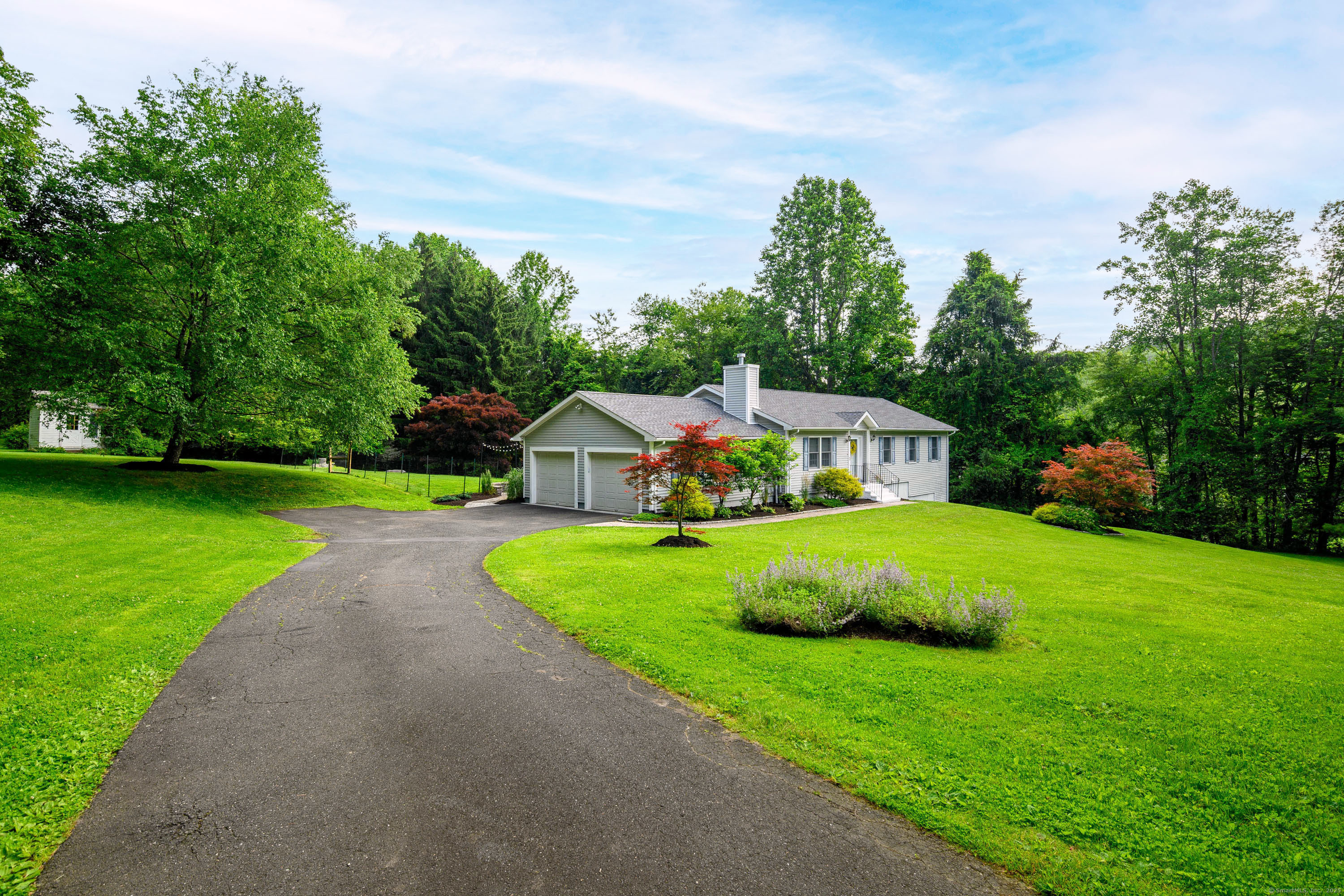 a front view of a house with garden