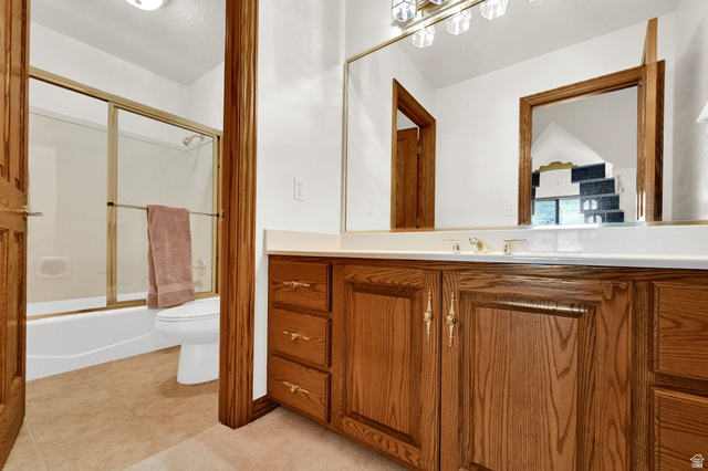 1085 Windsor Drive Provo, UT 84604 - Photo 44 of 83 Bathroom with vanity, bath / shower combo with glass door, and light tile patterned floors