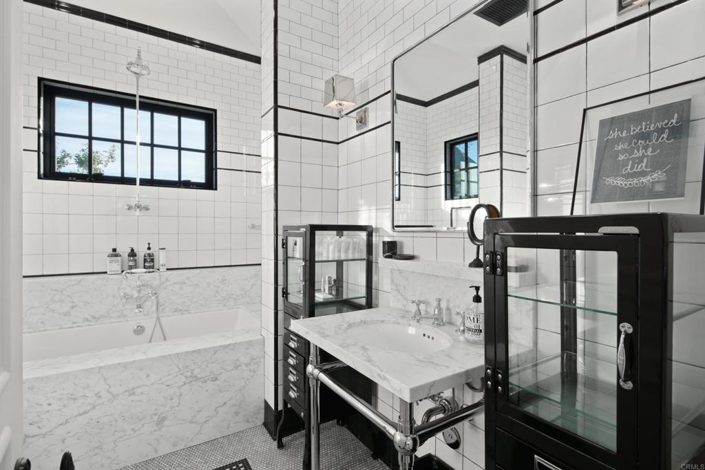 1314 Lake Drive Encinitas, CA 92007 - Photo 54 of 73 a bathroom with a granite countertop sink a mirror and shower