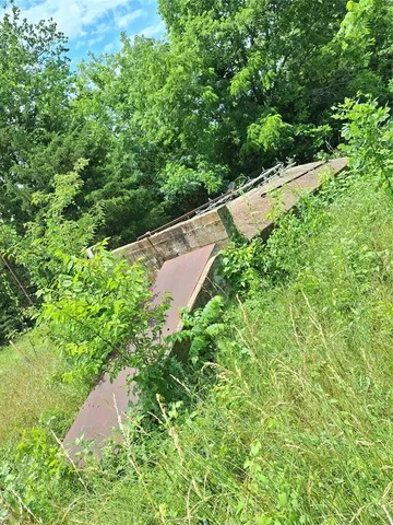 a view of a field with an ocean