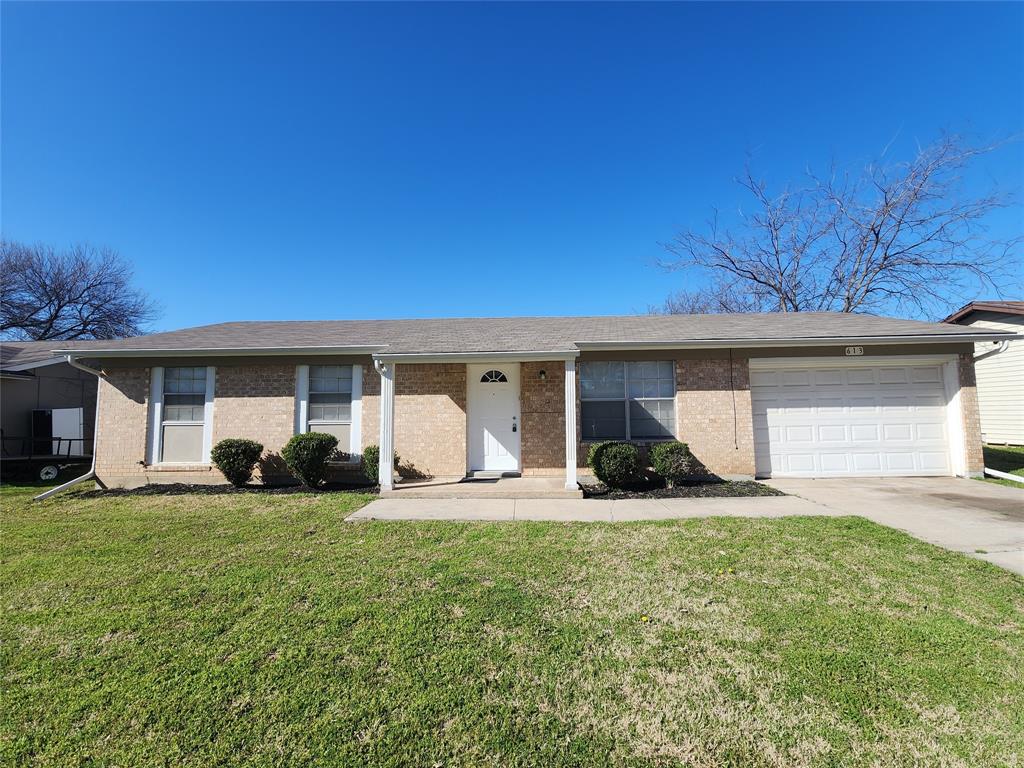 a front view of a house with yard and green space