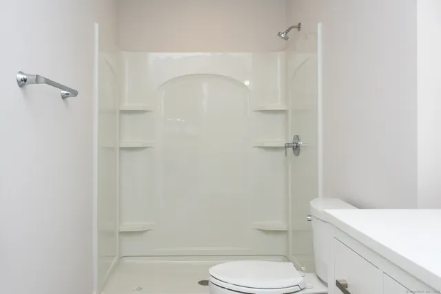 a white toilet sitting next to a bathroom sink