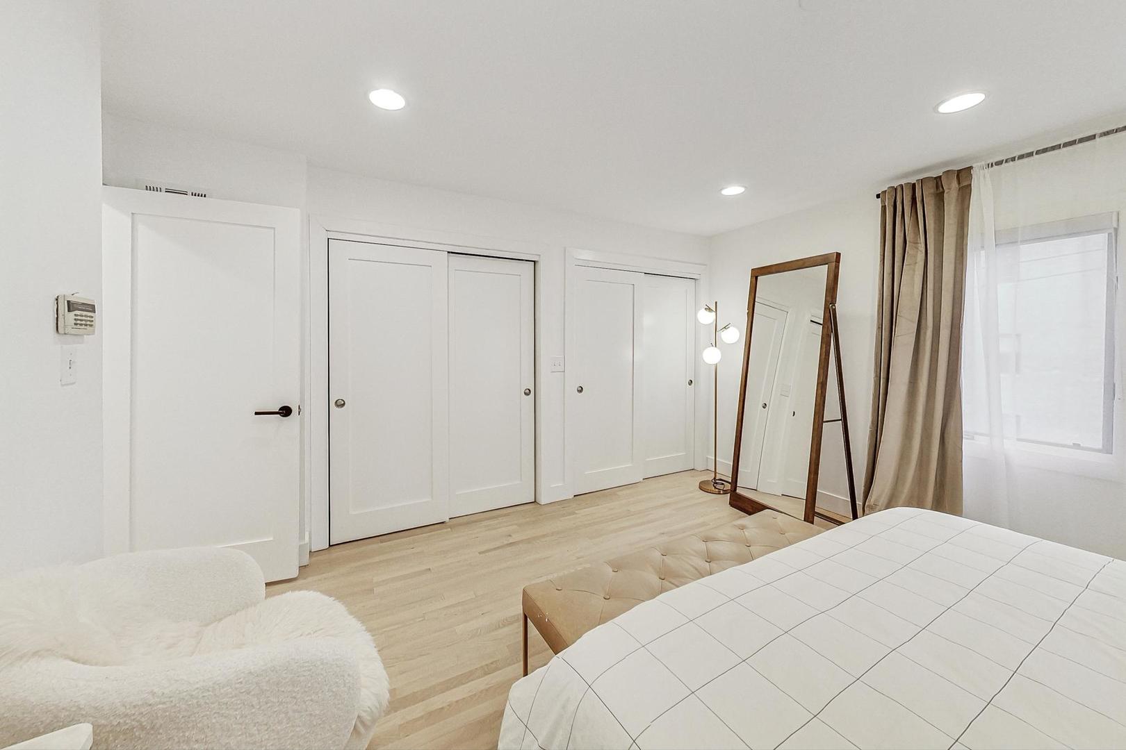 448 North Carpenter Street, Unit J Chicago, IL 60642 - Photo 16 of 39 a bedroom with a bed and a couch