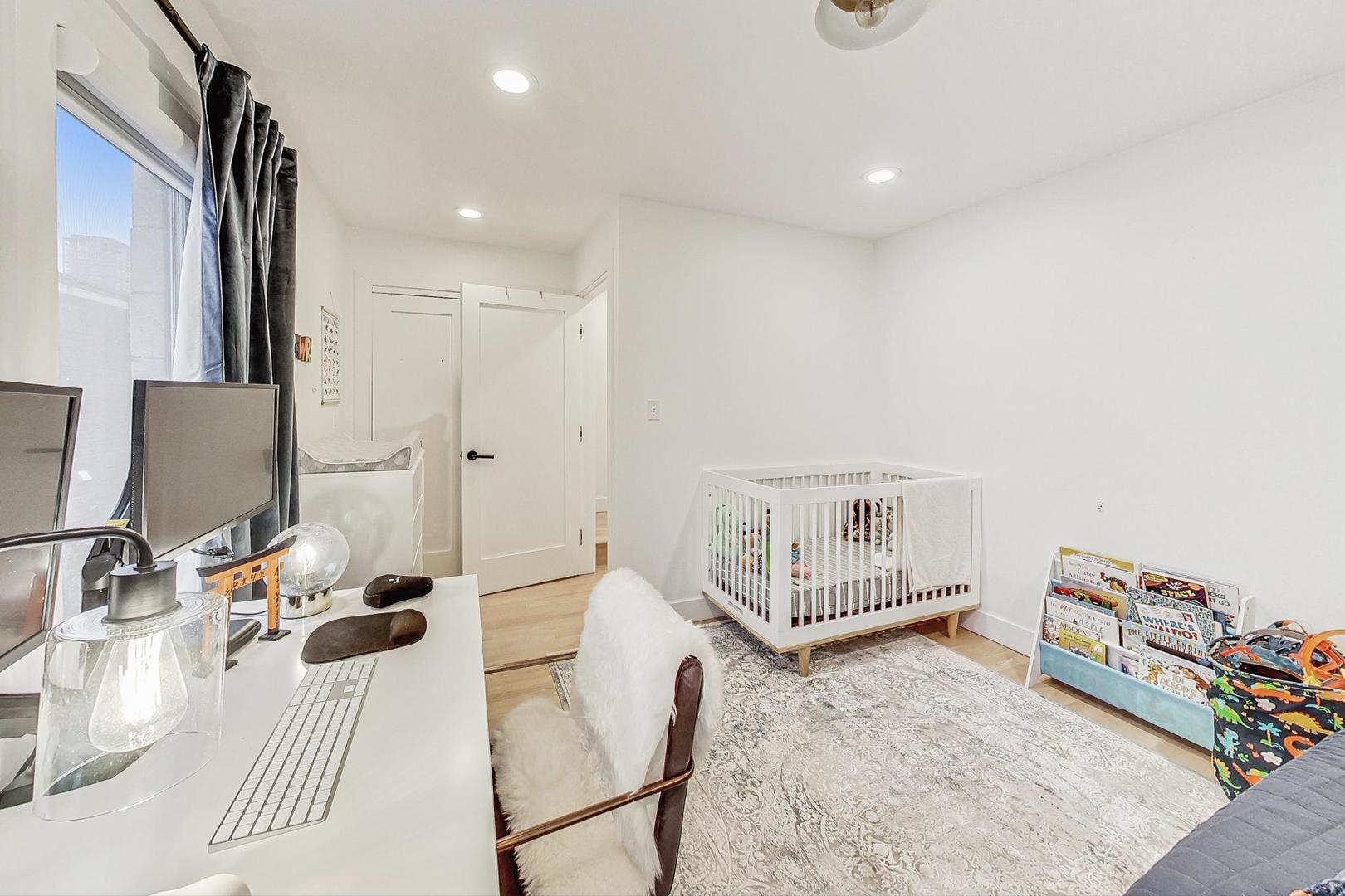 448 North Carpenter Street, Unit J Chicago, IL 60642 - Photo 18 of 39 a bedroom with furniture and a chandelier