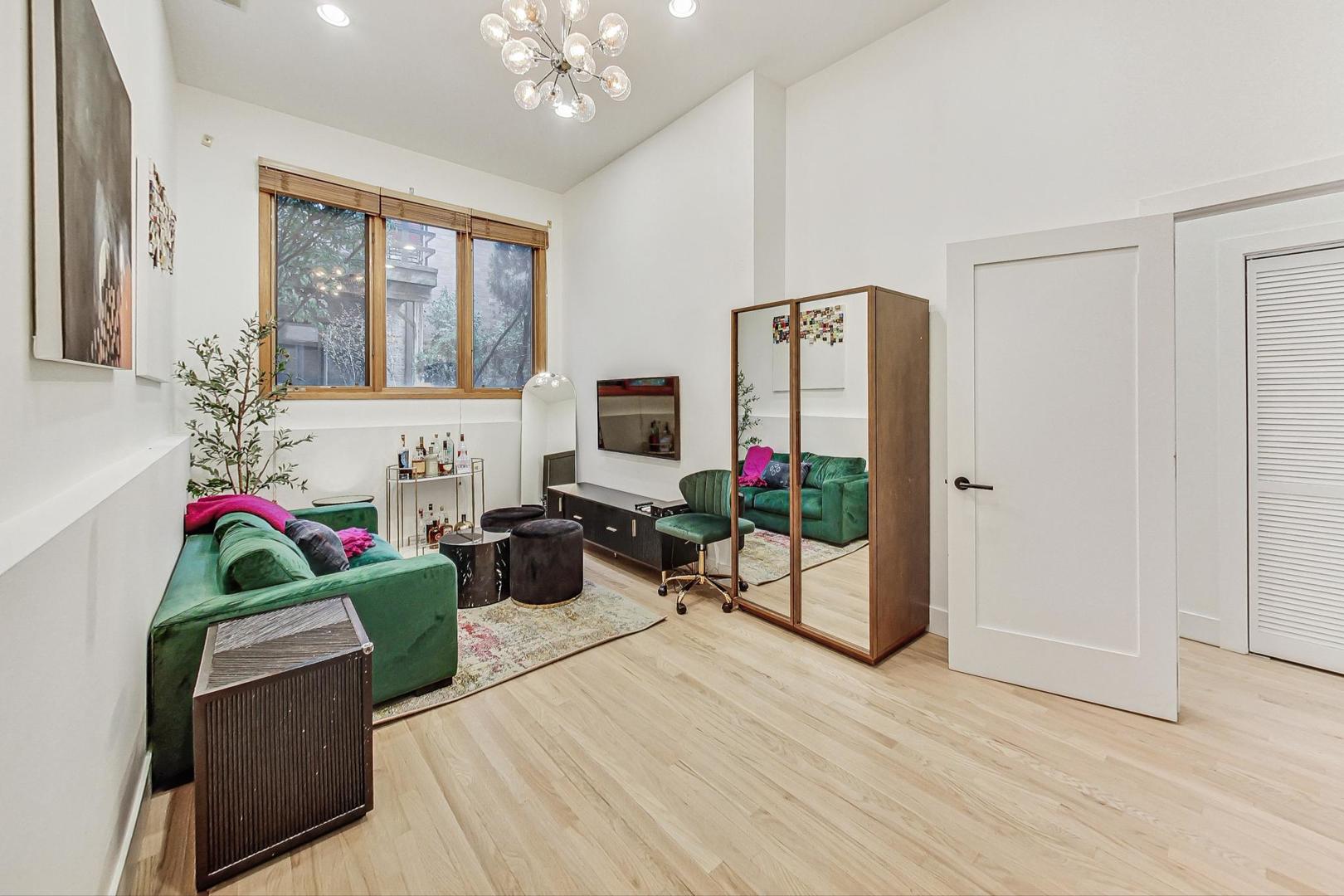 448 North Carpenter Street, Unit J Chicago, IL 60642 - Photo 28 of 39 a living room with furniture and a flat screen tv