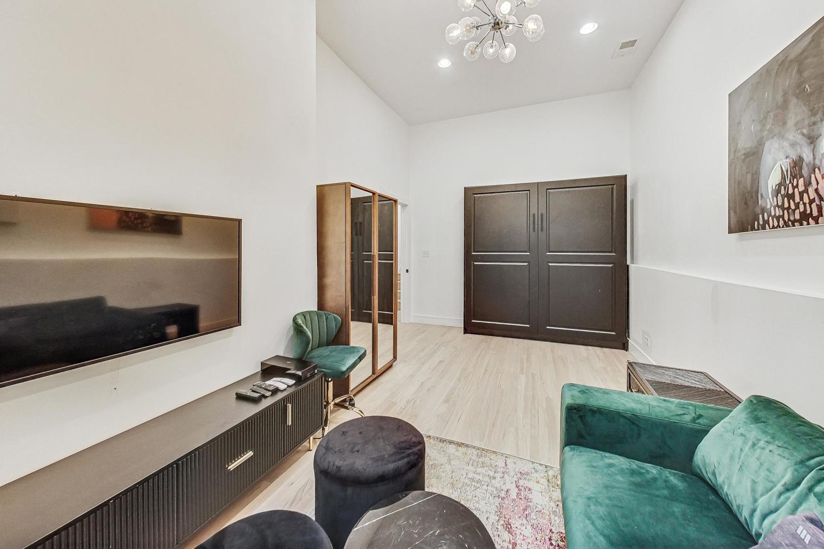 448 North Carpenter Street, Unit J Chicago, IL 60642 - Photo 30 of 39 a living room with furniture and a flat screen tv