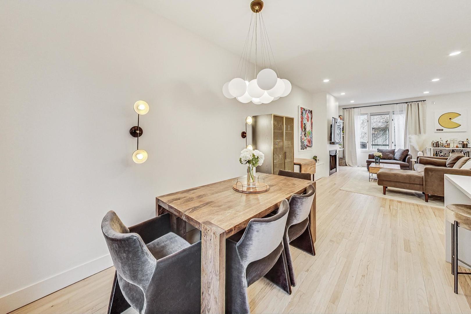 448 North Carpenter Street, Unit J Chicago, IL 60642 - Photo 9 of 39 a view of a dining room with furniture and wooden floor