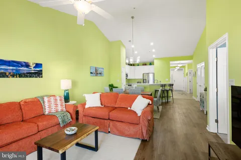 a living room with furniture wooden floor and a chandelier