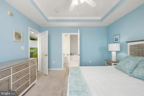 a bedroom with a bed and a lamp on dresser