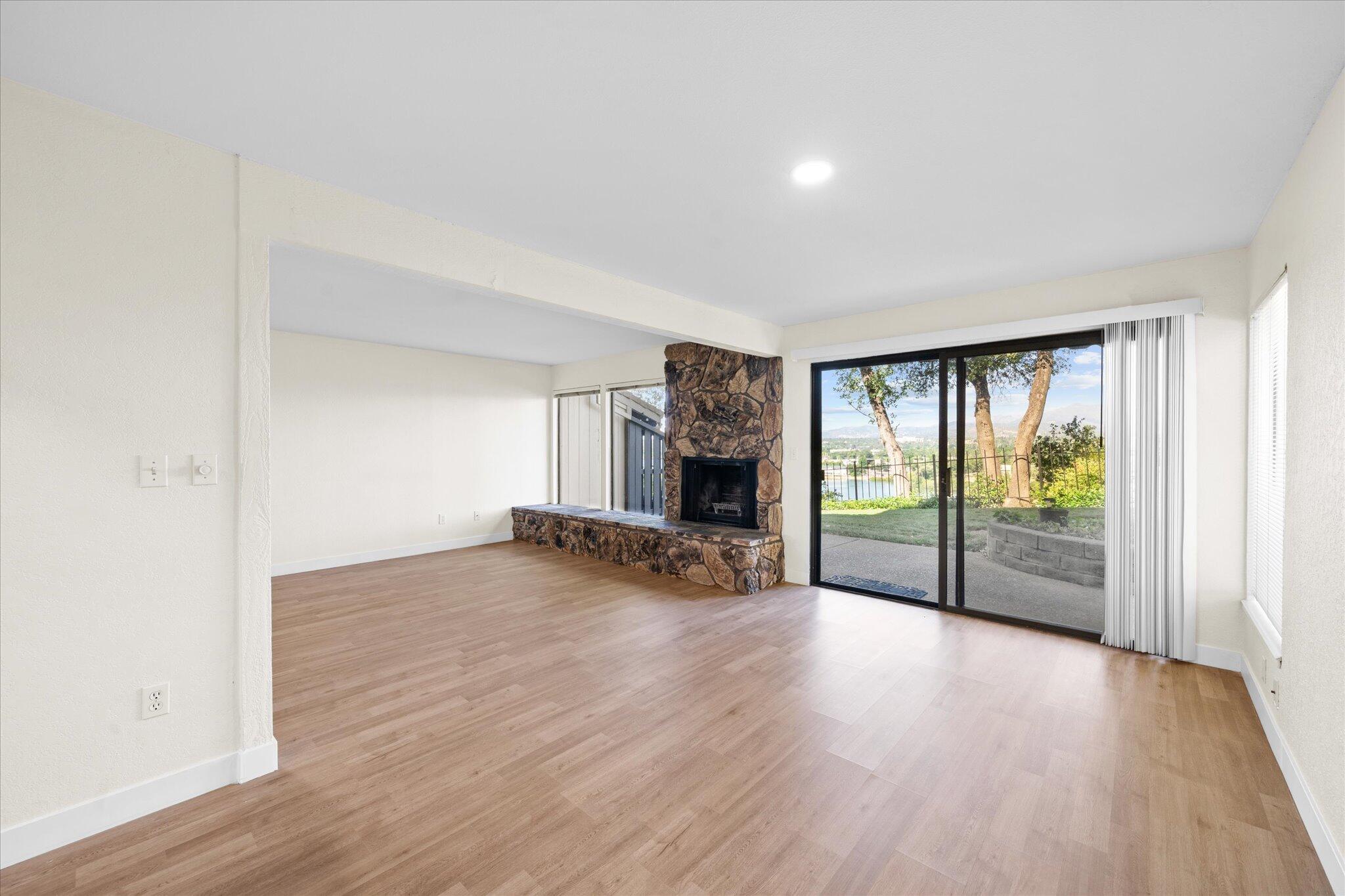 1954 Bechelli Lane Redding, CA 96002 - Photo 13 of 44 an empty room with wooden floor and windows