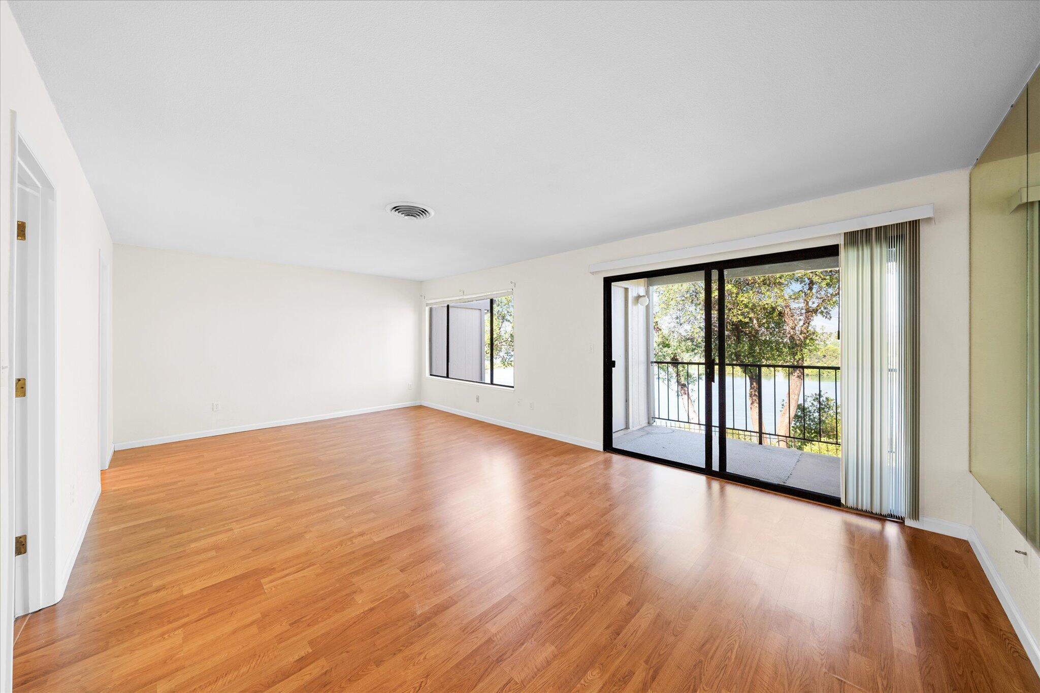 1954 Bechelli Lane Redding, CA 96002 - Photo 17 of 44 a view of an empty room with wooden floor and a window