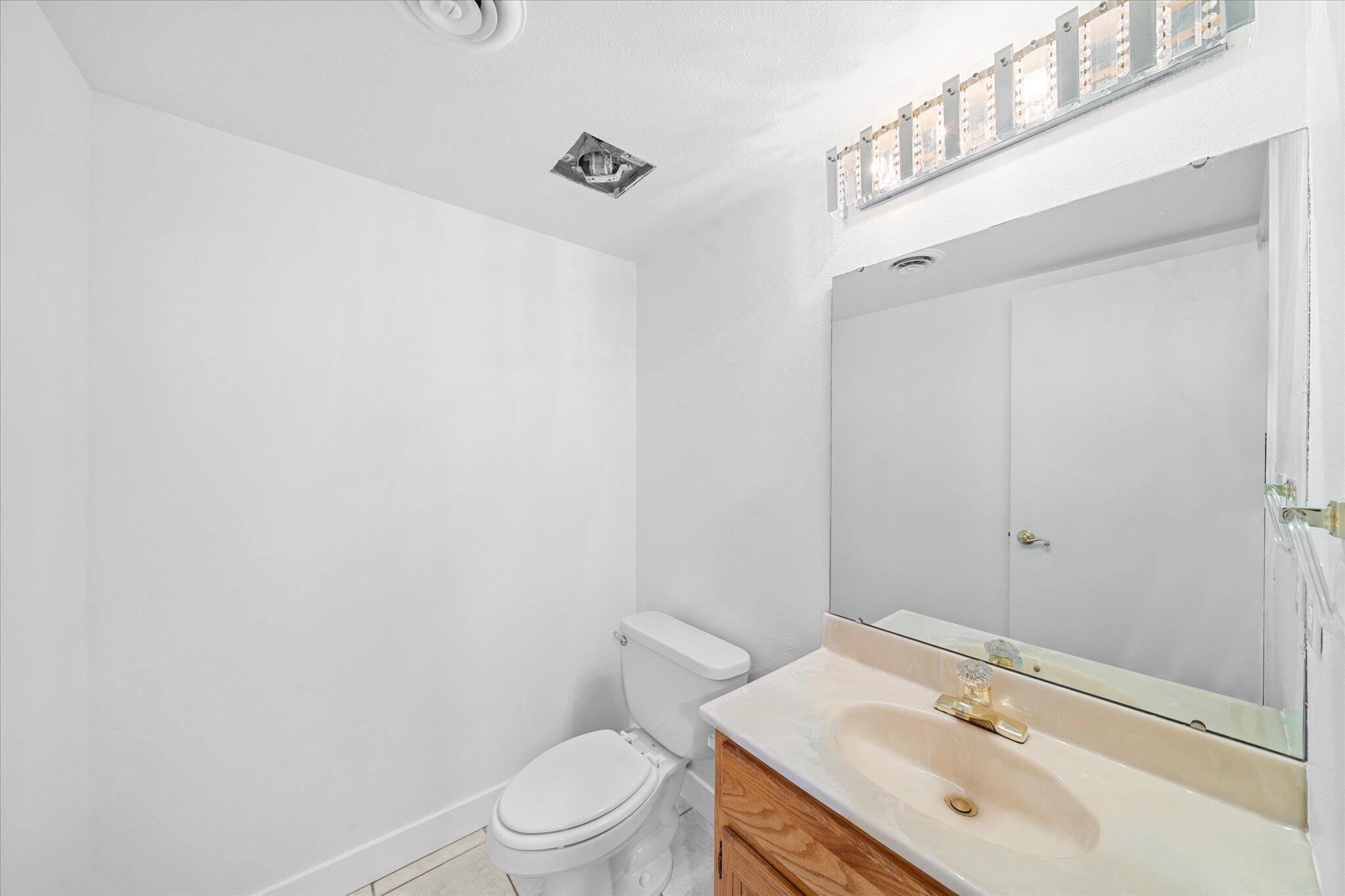 1954 Bechelli Lane Redding, CA 96002 - Photo 29 of 44 a bathroom with a sink toilet and vanity