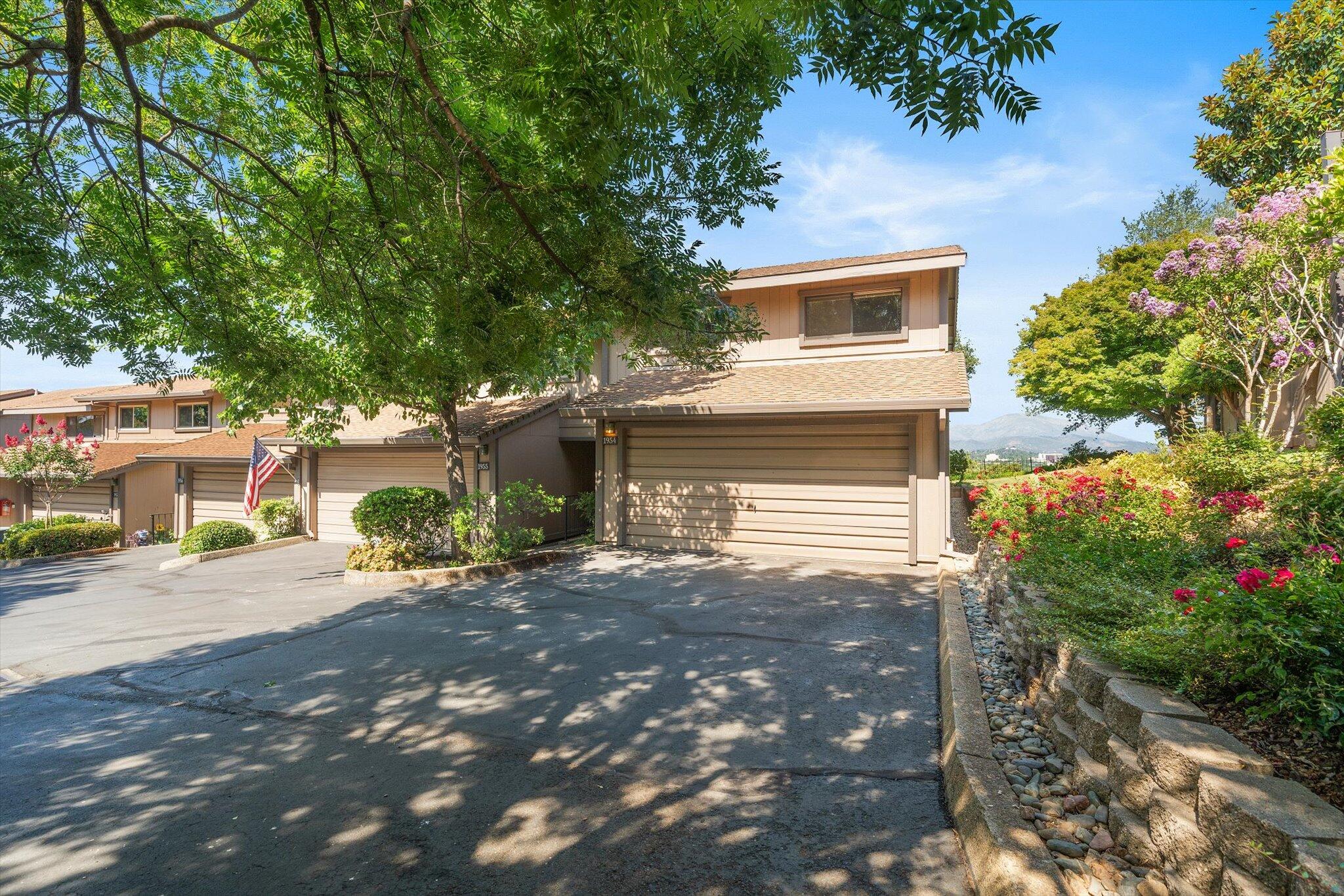 1954 Bechelli Lane Redding, CA 96002 - Photo 3 of 44 a front view of a house with a yard and a garage