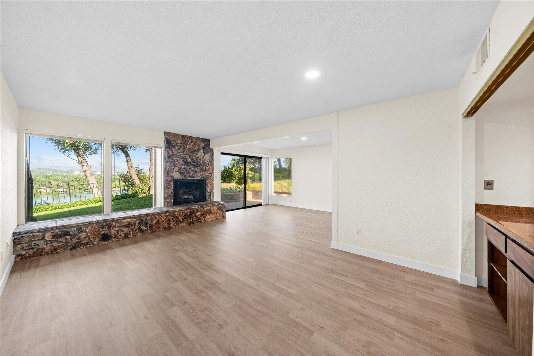 1954 Bechelli Lane Redding, CA 96002 - Photo 7 of 44 an empty room with wooden floor and windows
