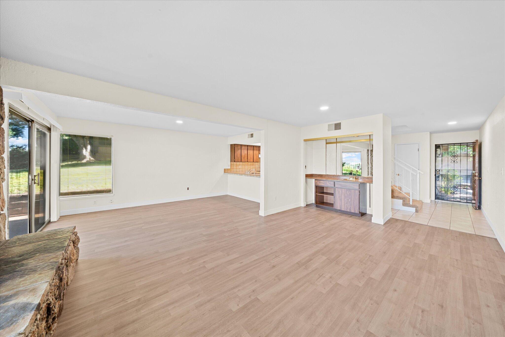 1954 Bechelli Lane Redding, CA 96002 - Photo 8 of 44 a view of an empty room with a window and wooden floor