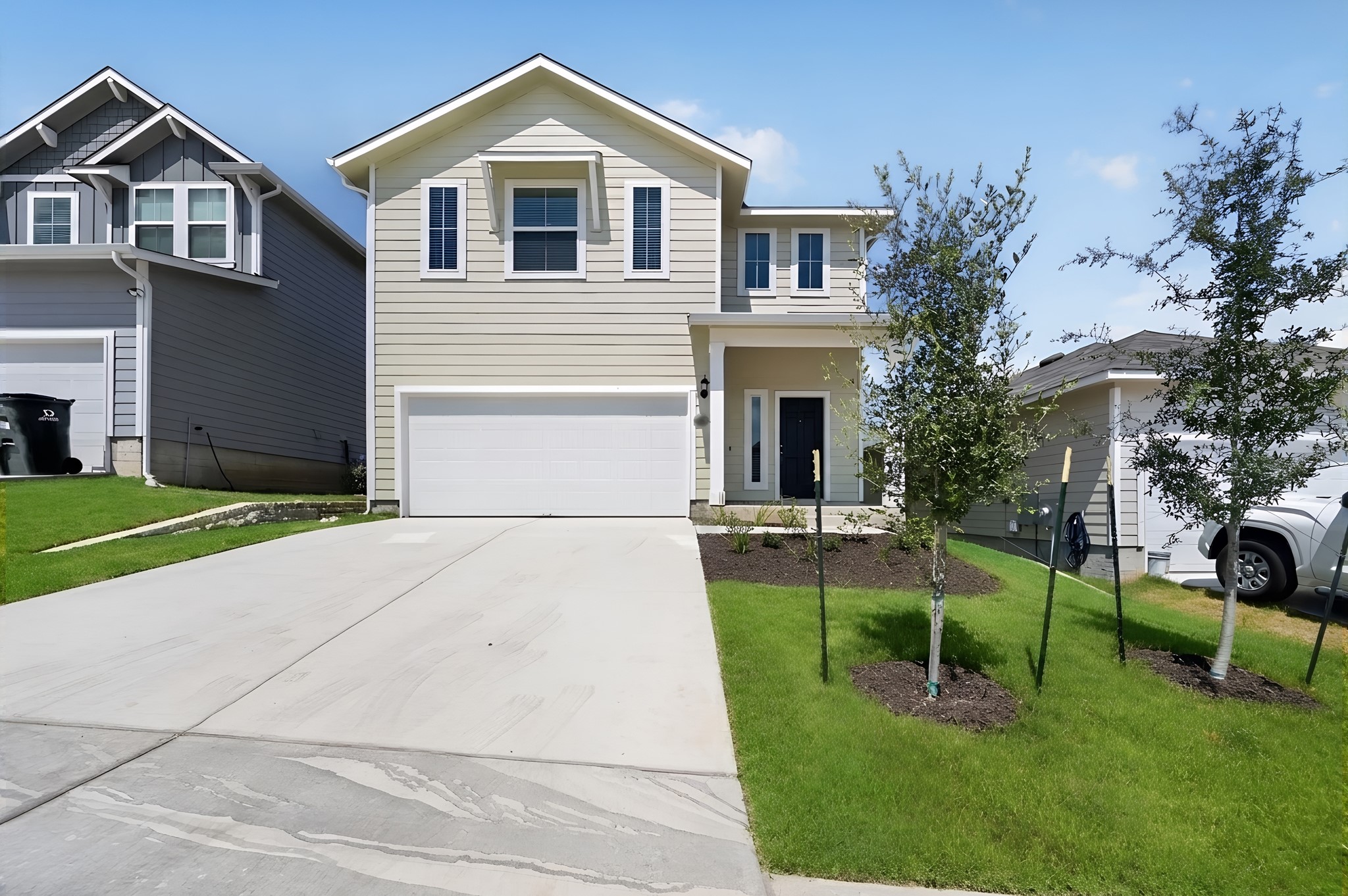 2704 Towy Road Manor, TX 78653 - Photo 1 of 36 Clean lines and a spacious driveway define this modern two-story exterior facade.