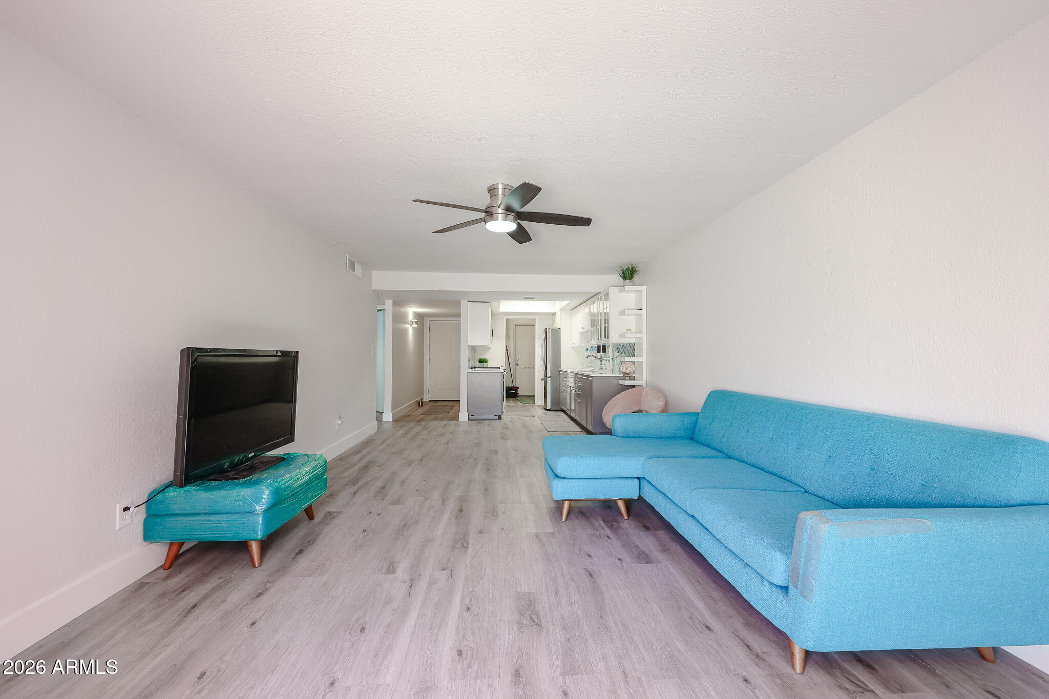5114 East Monte Vista Road Phoenix, AZ 85008 - Photo 20 of 45 a living room with furniture and a flat screen tv