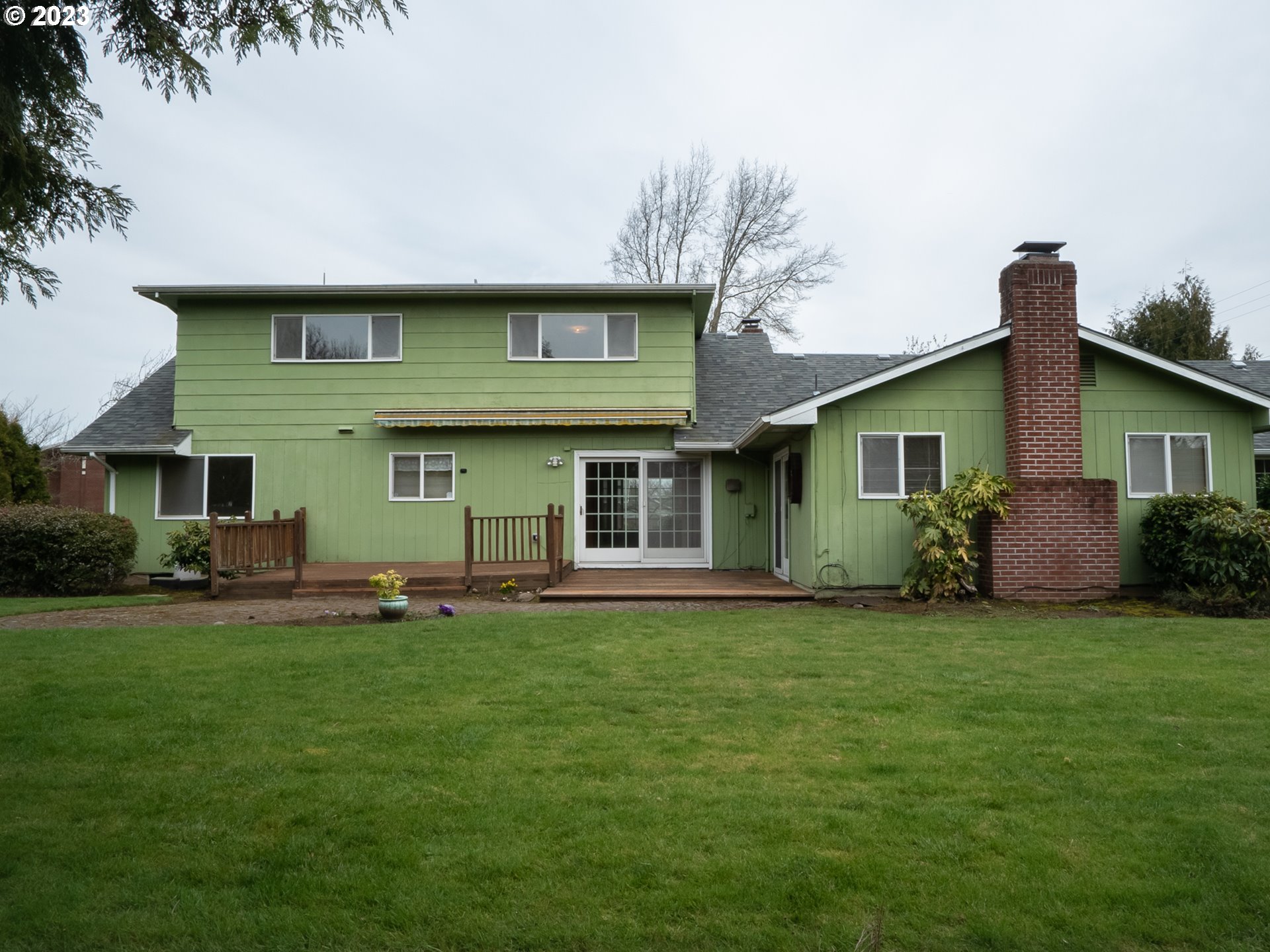 1124 President Street Eugene, OR 97401 - Photo 22 of 26 a front view of a house with a garden and trees