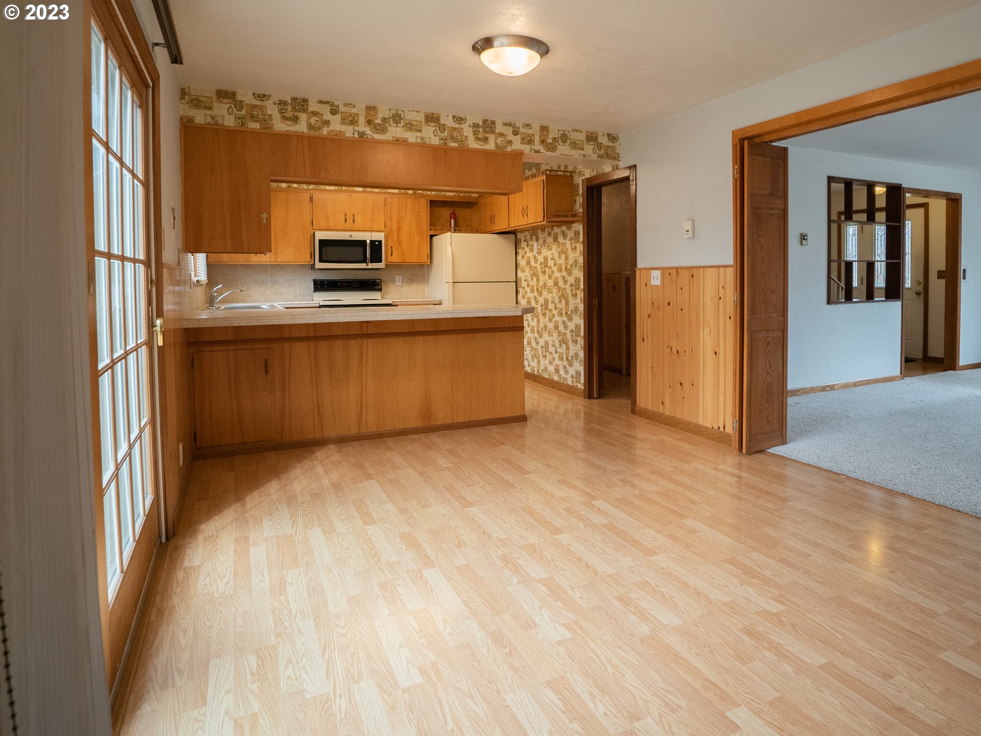 1124 President Street Eugene, OR 97401 - Photo 7 of 26 a view of kitchen with stainless steel appliances wooden floor and large window