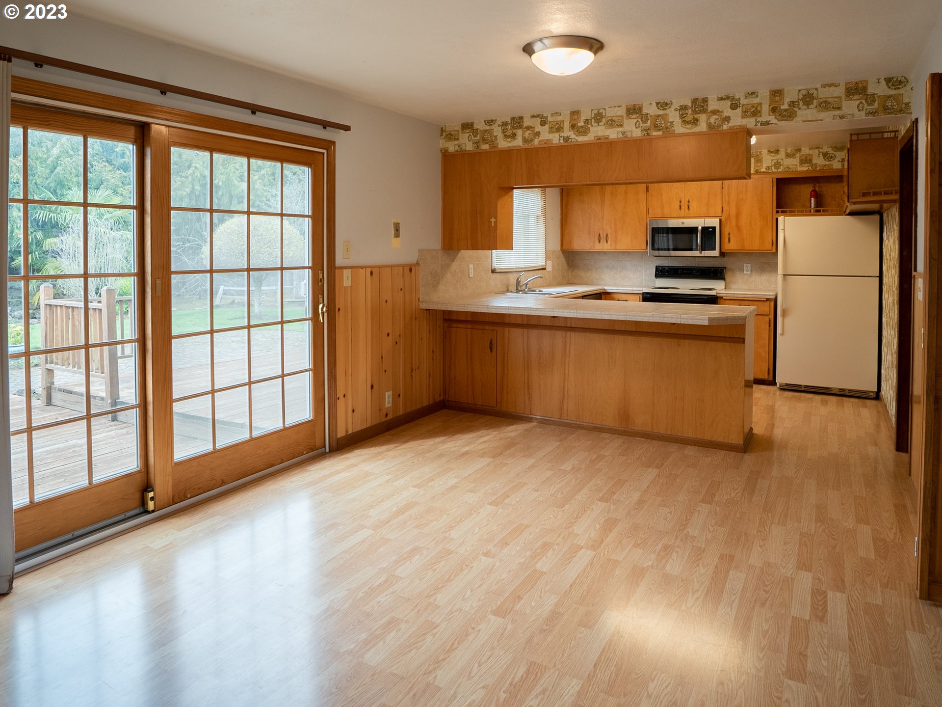 1124 President Street Eugene, OR 97401 - Photo 8 of 26 a kitchen with stainless steel appliances a refrigerator and a stove top oven