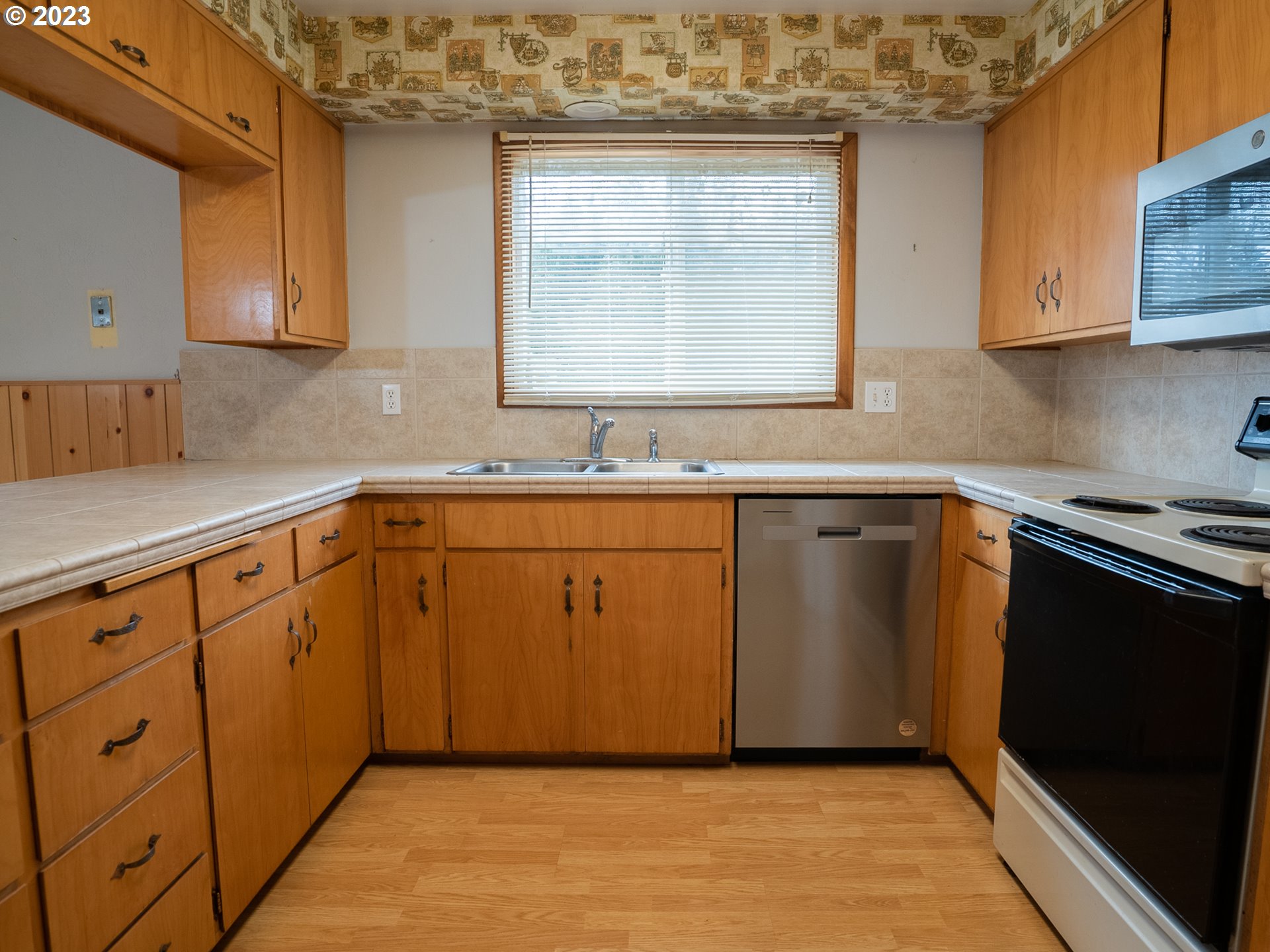 1124 President Street Eugene, OR 97401 - Photo 9 of 26 a kitchen with stainless steel appliances granite countertop a sink stove and cabinets