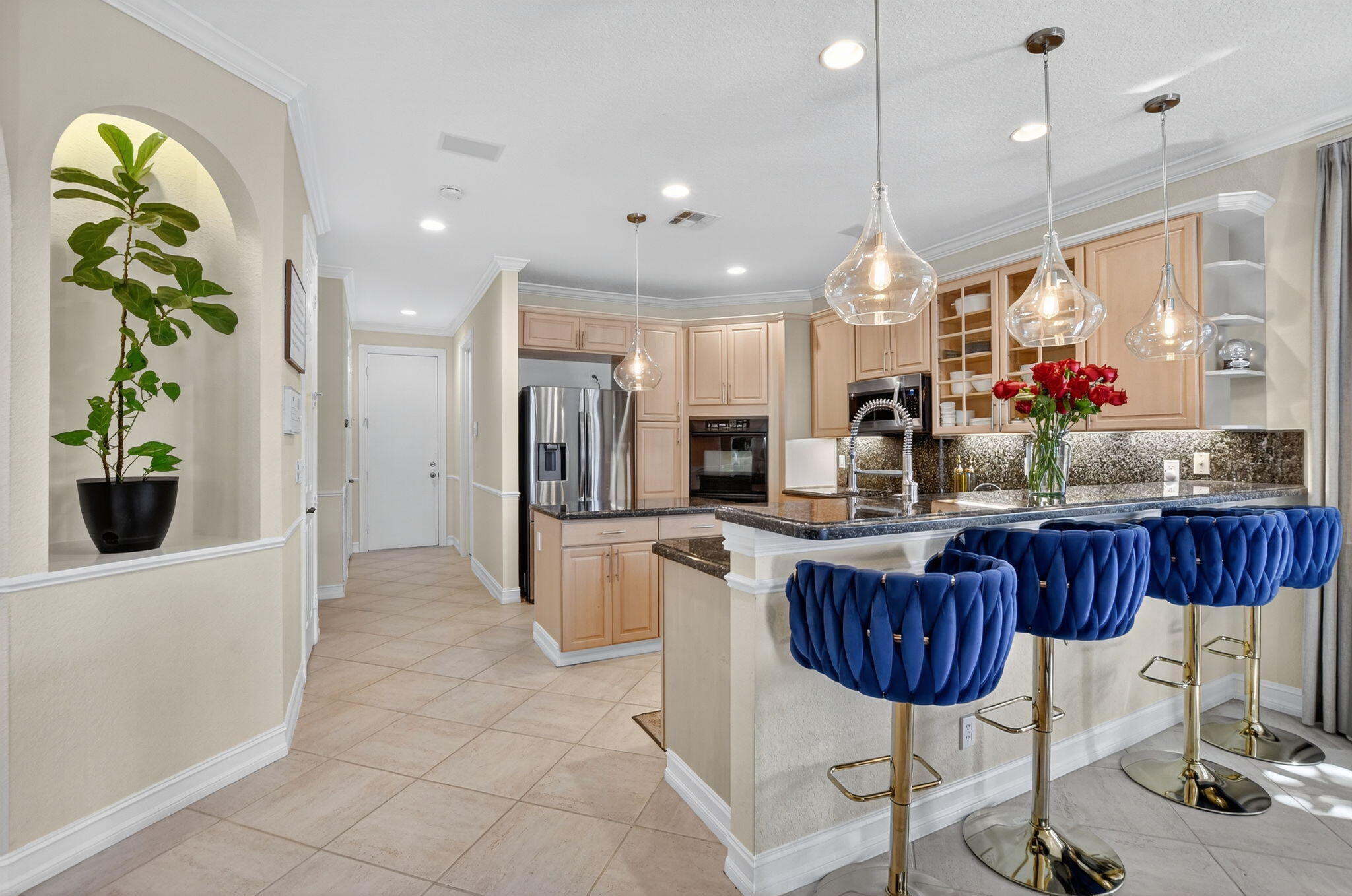 21383 Falls Ridge Way, Unit 1 Boca Raton, FL 33428 - Photo 14 of 44 a kitchen with stainless steel appliances granite countertop a refrigerator a sink a stove a dining table and chairs