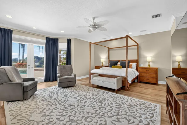 a bedroom with a bed couch and wooden floor