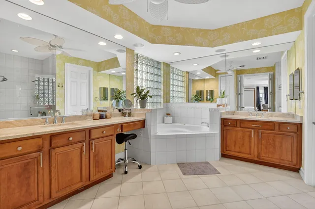 a large bathroom with a sink mirror vanity and bathtub