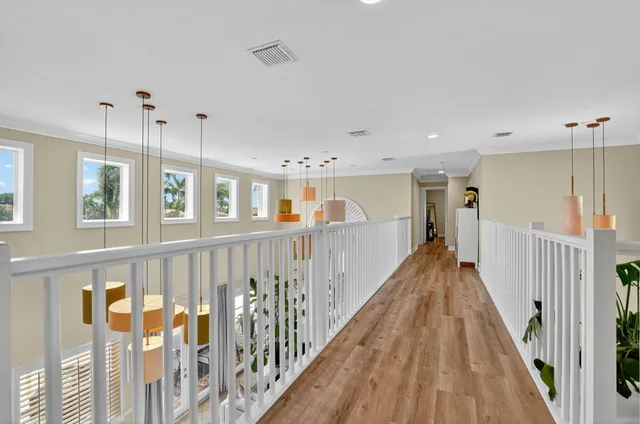 a view of hallway with wooden floor and stairs