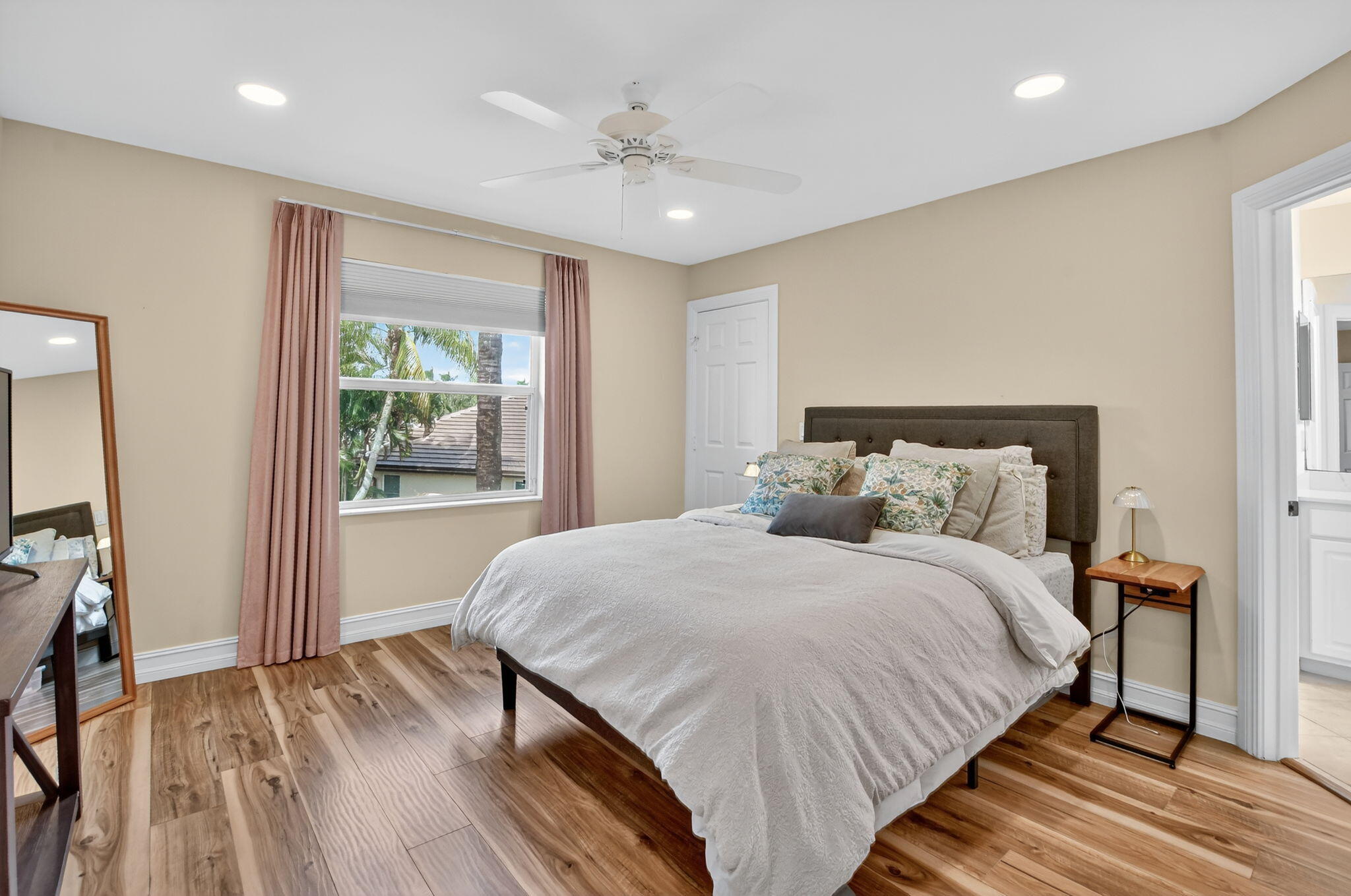 21383 Falls Ridge Way, Unit 1 Boca Raton, FL 33428 - Photo 25 of 44 a bedroom with a large bed and a chandelier