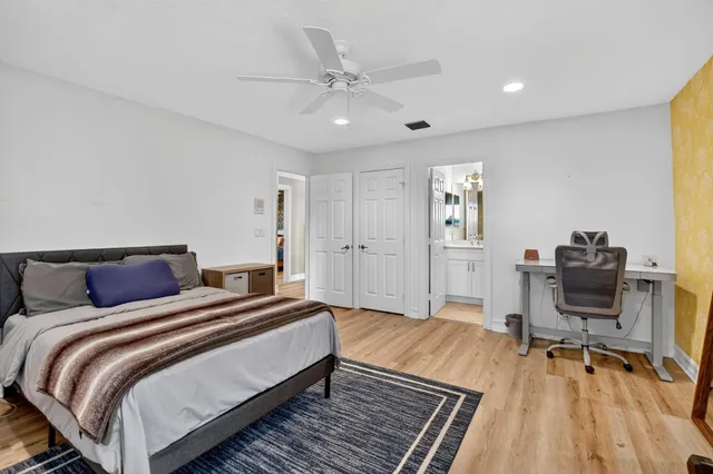 a spacious bedroom with a bed and a table