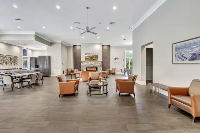 a living room with furniture and a dining table with kitchen view