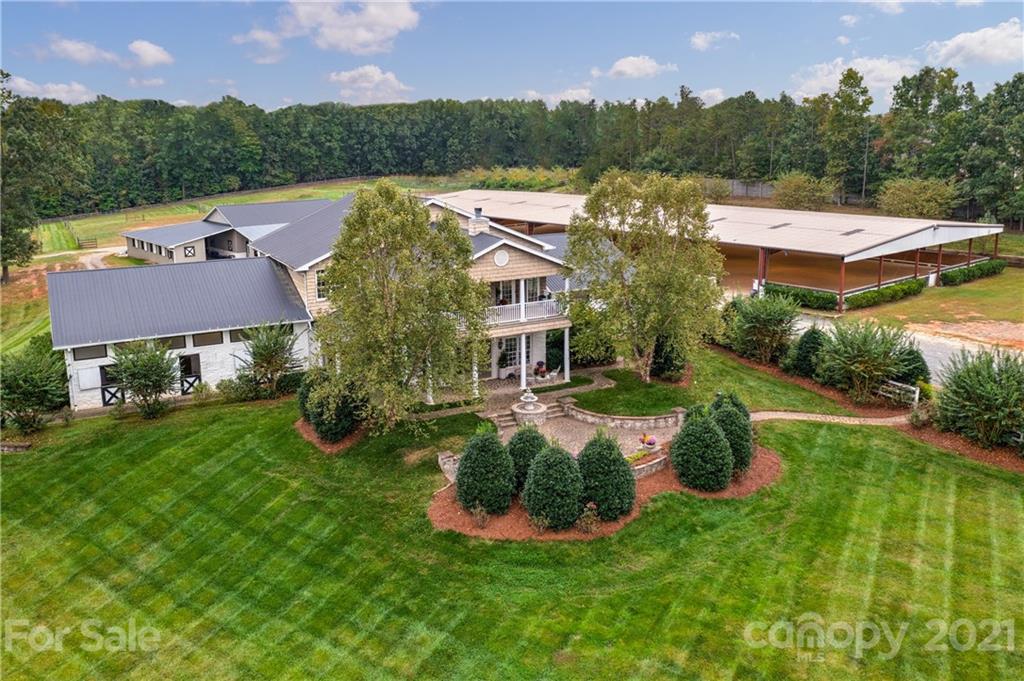 an aerial view of residential houses with outdoor space and lake view