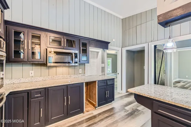 a front view of a house with a garden and yard