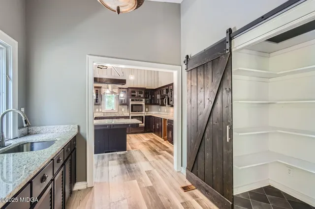 a view of a house with a large window and yard