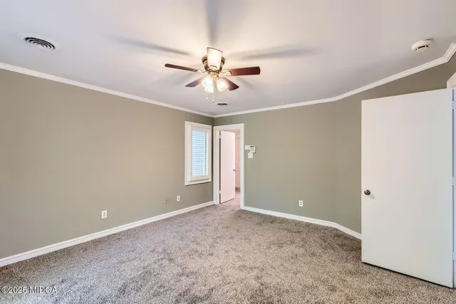 a view of a patio with table and chairs under an umbrella