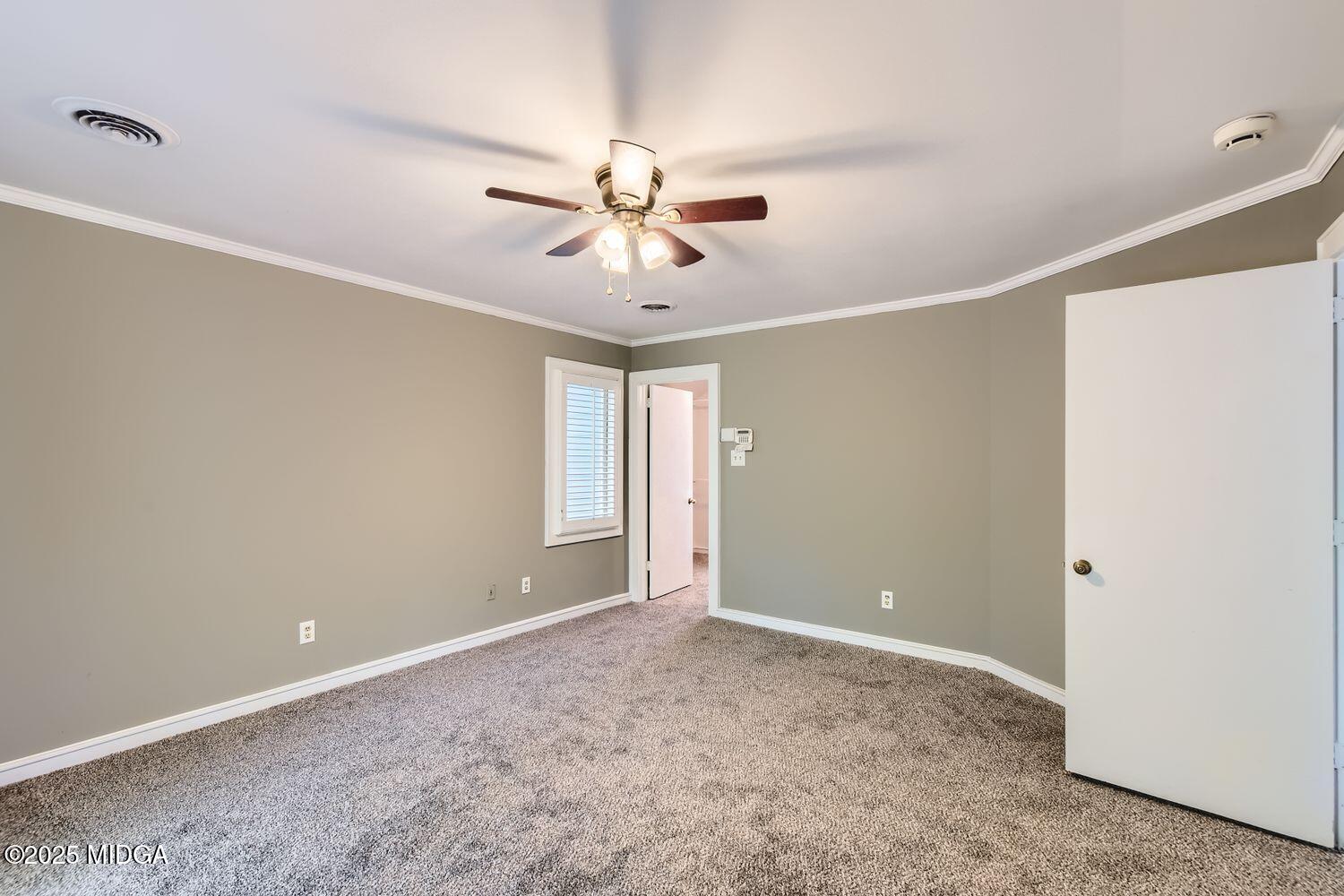 545 North Pine Hill Road Griffin, GA 30223 - Photo 16 of 39 a view of a room with a ceiling fan and a window