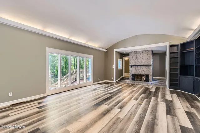 a view of a room with a ceiling fan and a window