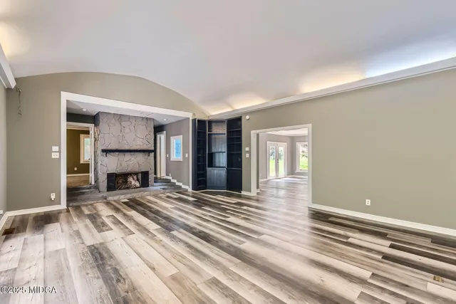 a view of an empty room with a ceiling fan