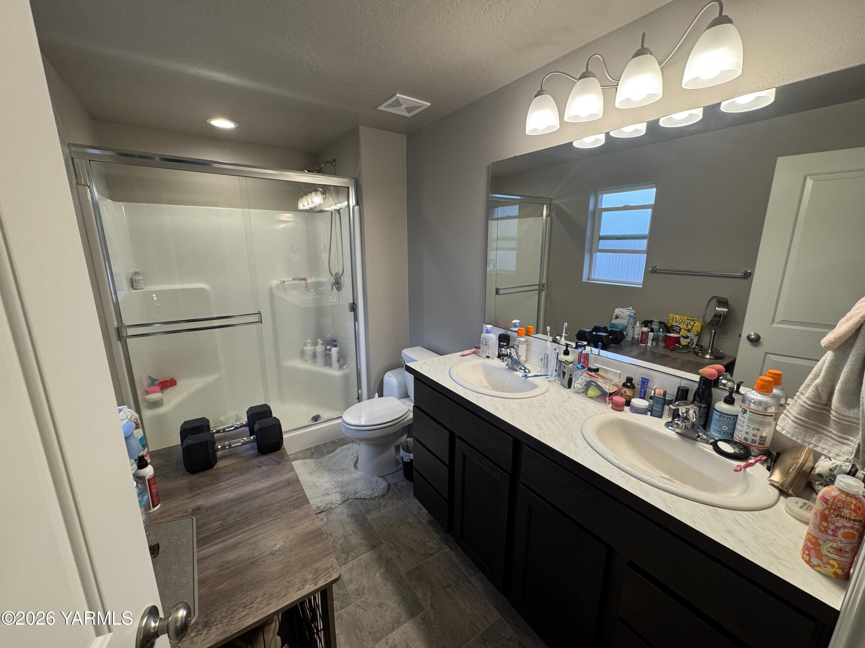 6104 Whitman Avenue Yakima, WA 98903 - Photo 12 of 19 a bathroom with a sink double vanity and a mirror