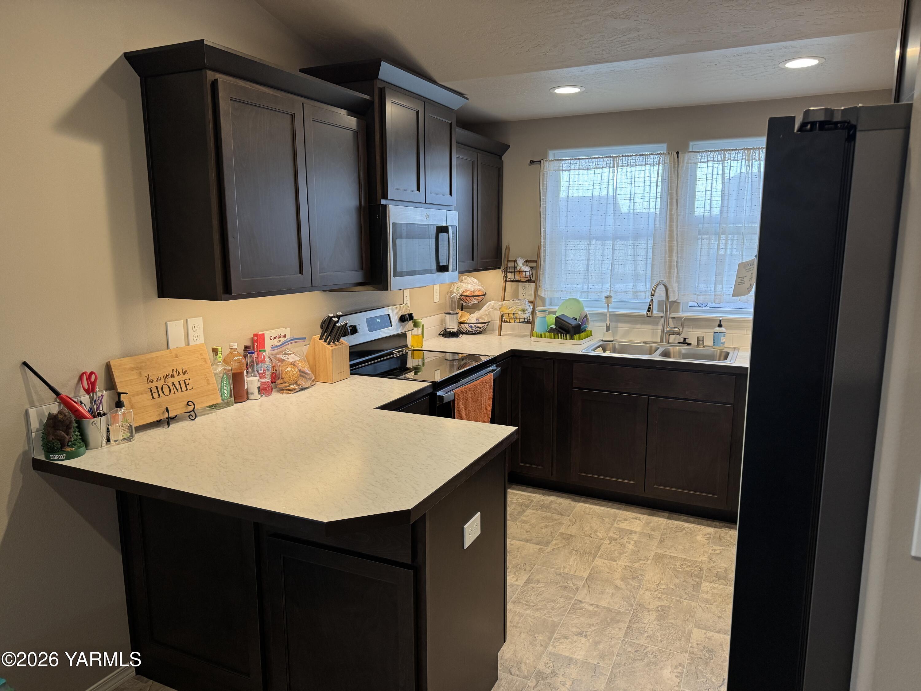 6104 Whitman Avenue Yakima, WA 98903 - Photo 6 of 19 a kitchen with a sink and cabinets