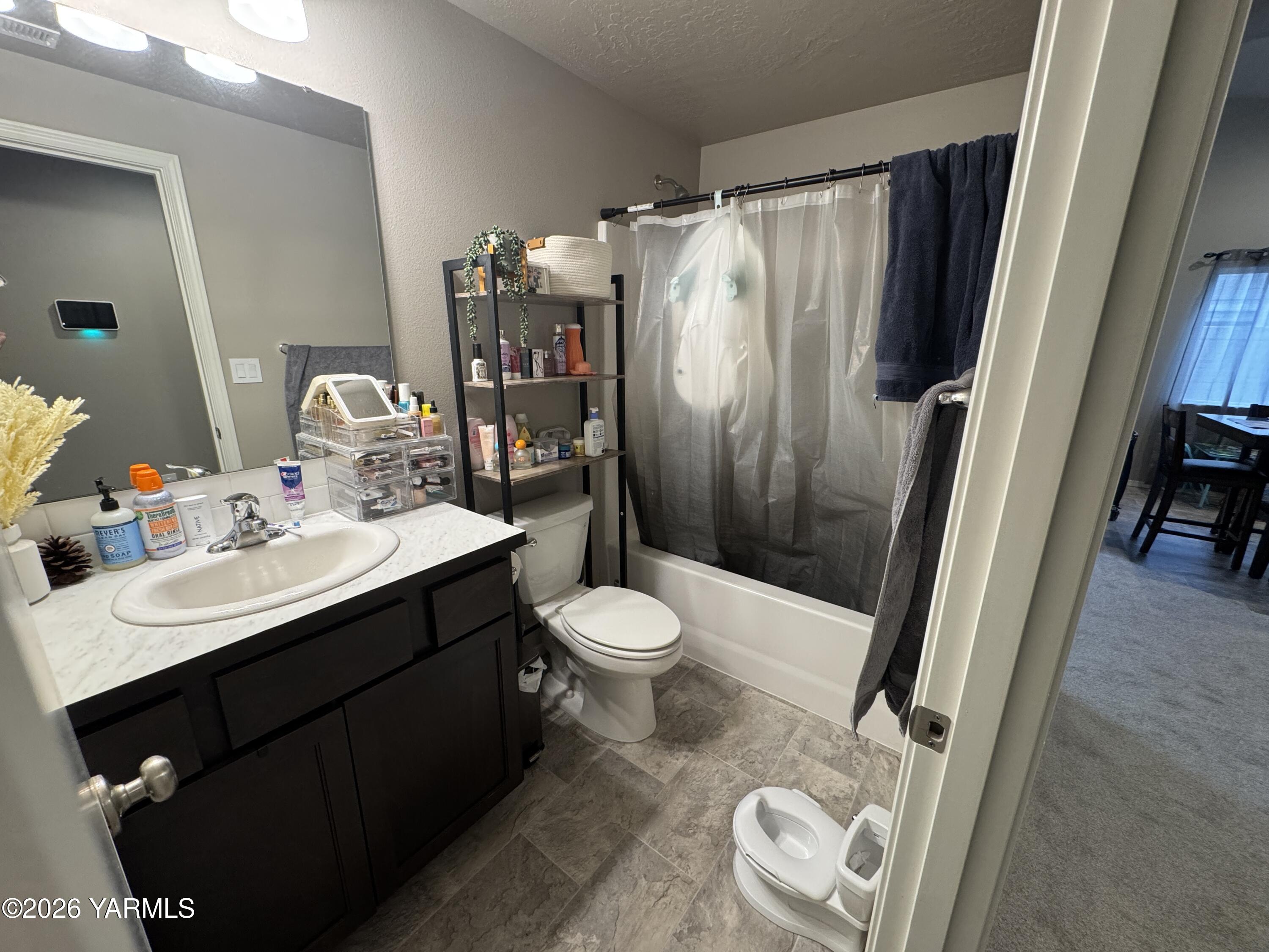 6104 Whitman Avenue Yakima, WA 98903 - Photo 9 of 19 a bathroom with a sink toilet and shower