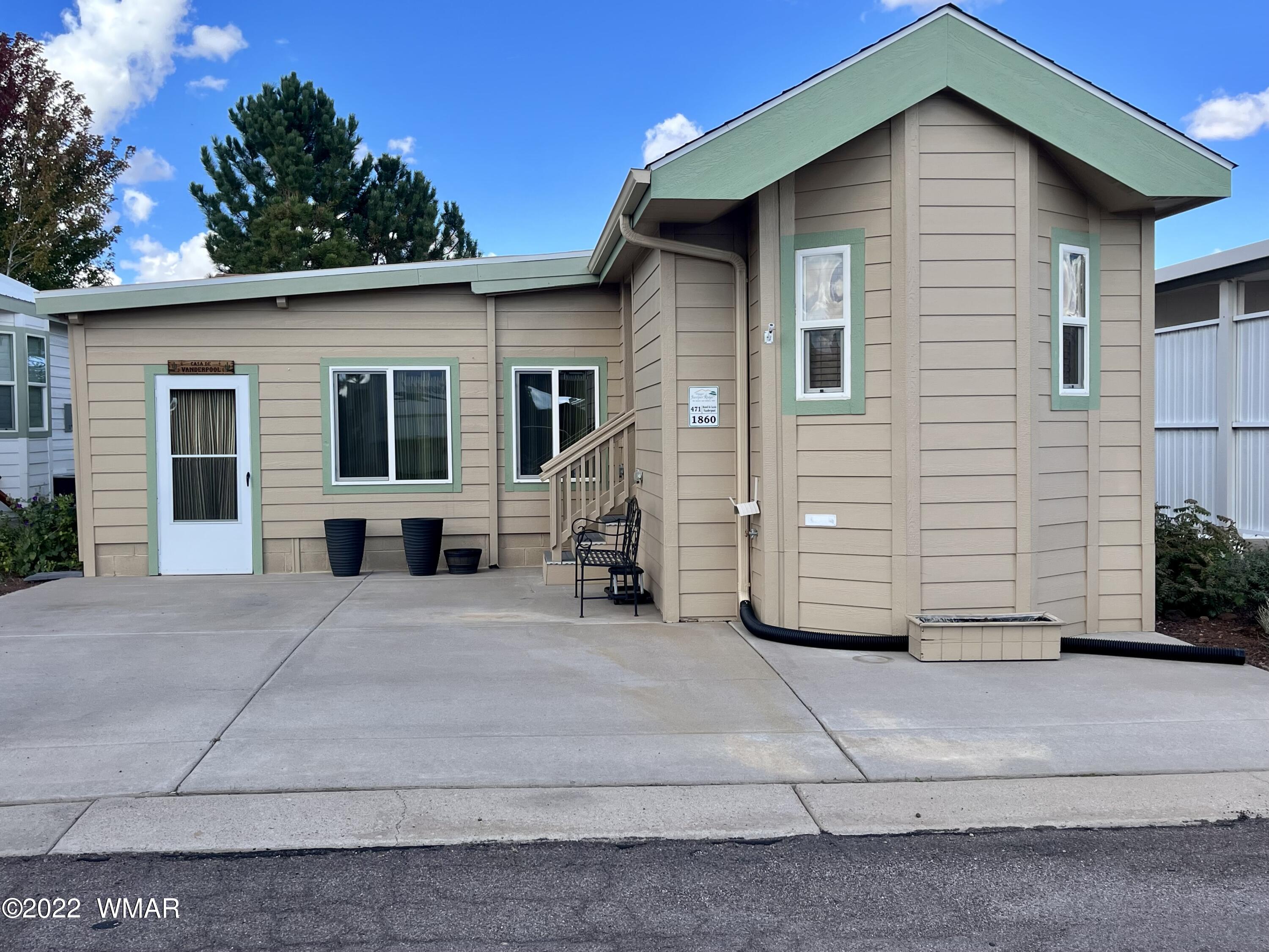 1860 Reel Way, Unit 471 Show Low, AZ 85901 - Photo 1 of 28 a front view of a house with a yard
