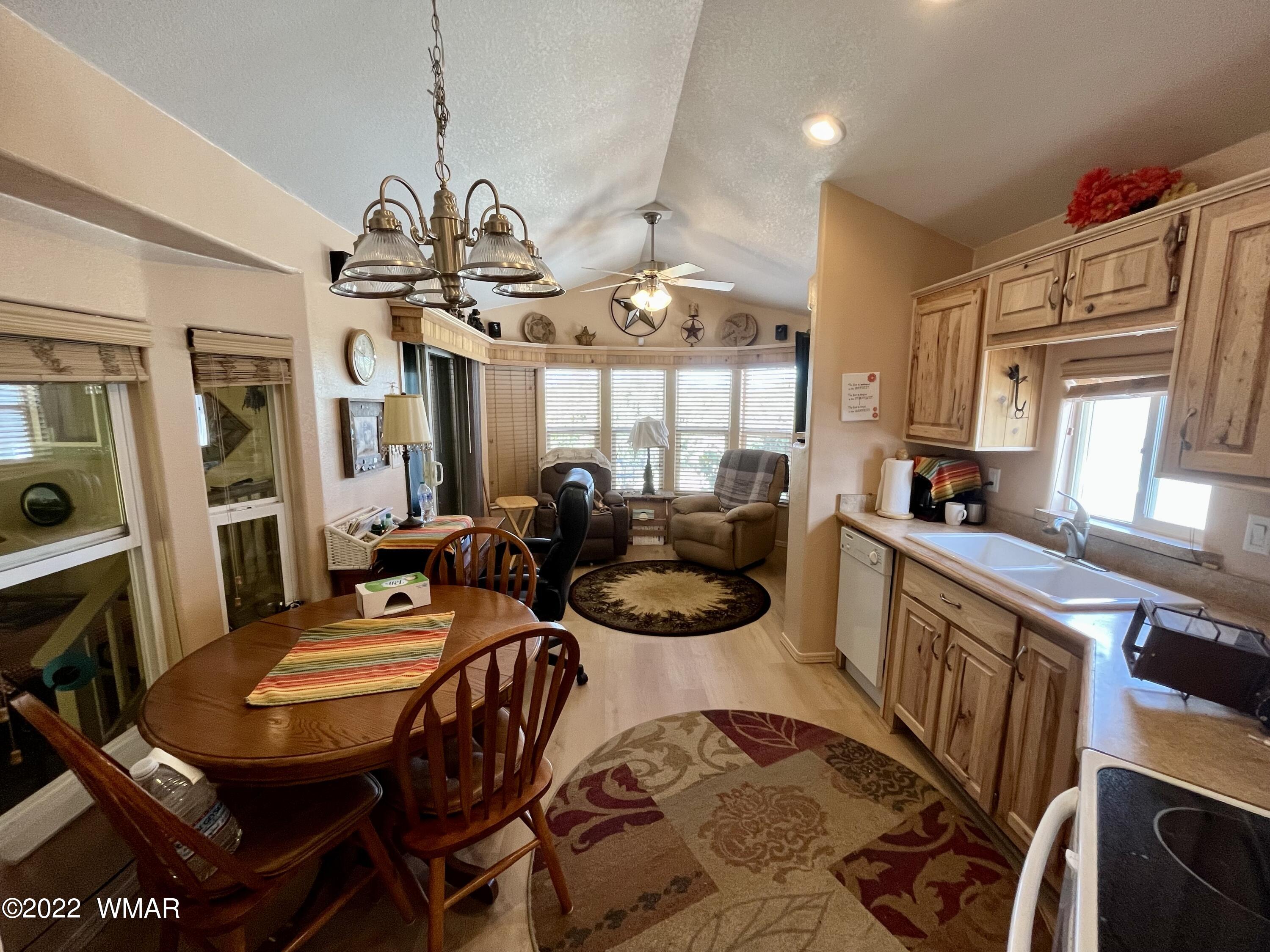 1860 Reel Way, Unit 471 Show Low, AZ 85901 - Photo 11 of 28 a kitchen with a table and chairs in it