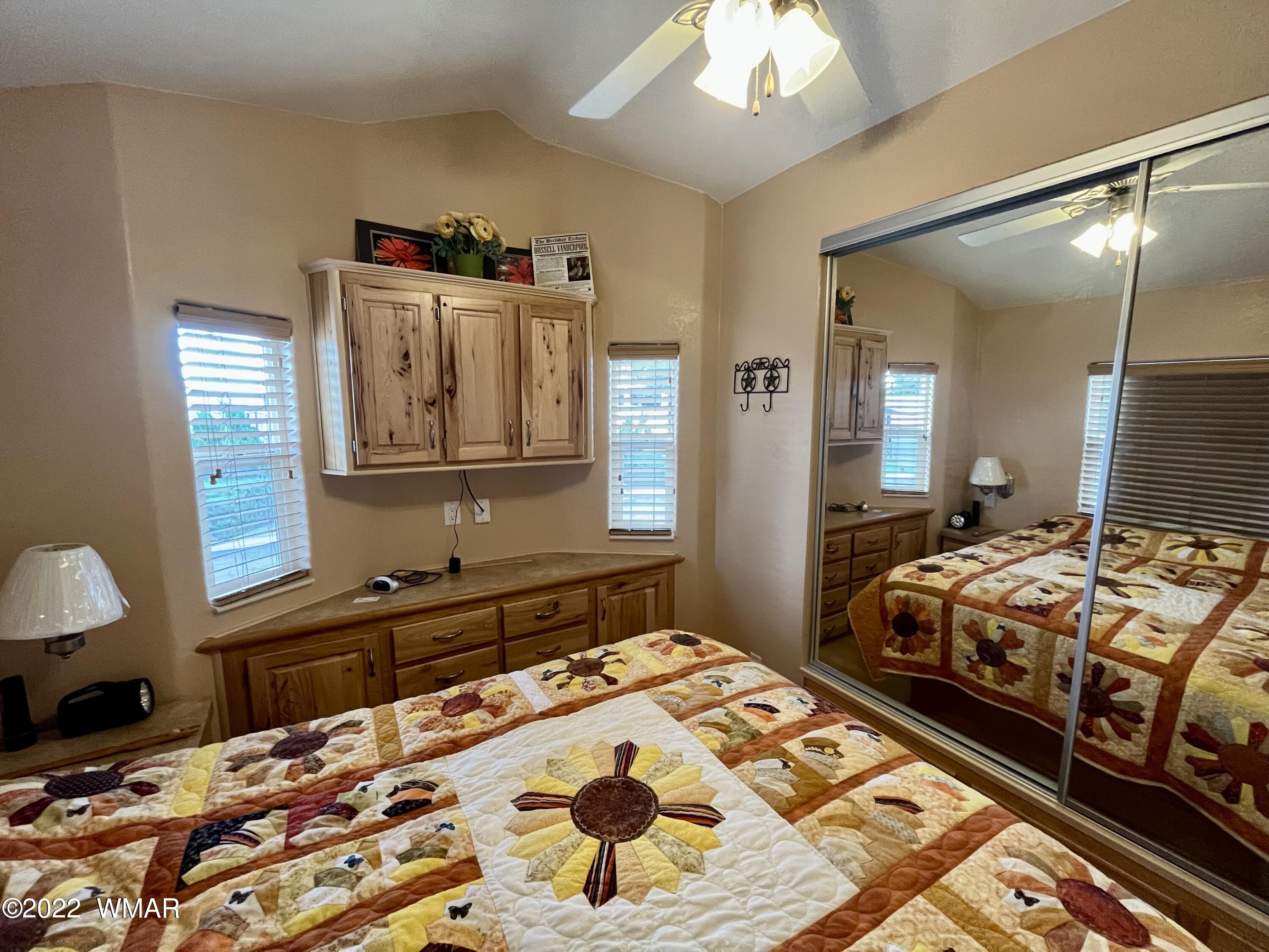 1860 Reel Way, Unit 471 Show Low, AZ 85901 - Photo 13 of 28 a bedroom with bed and a chandelier