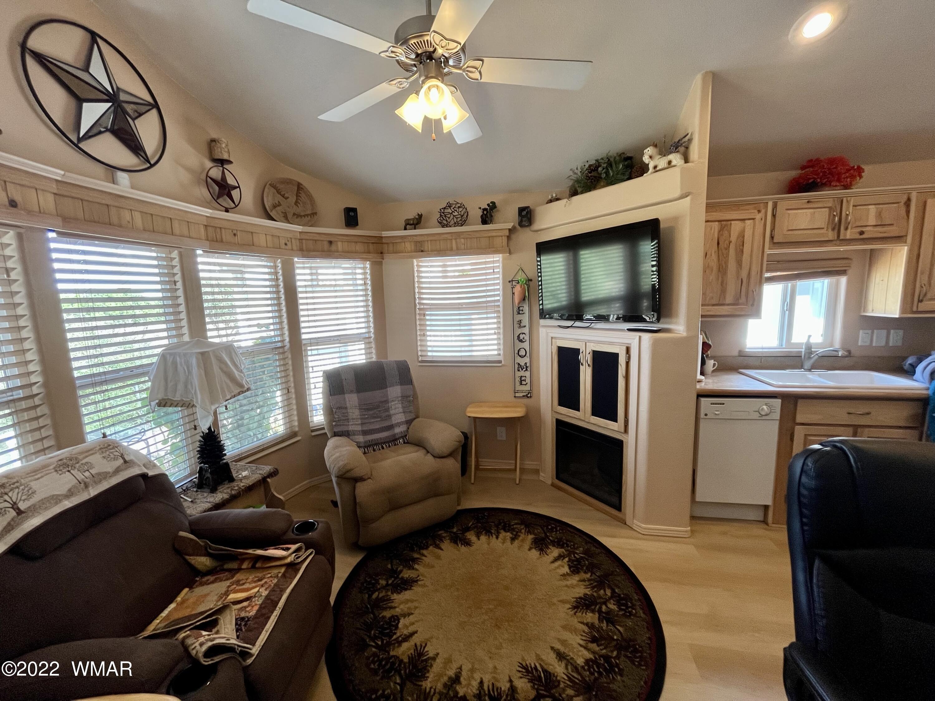1860 Reel Way, Unit 471 Show Low, AZ 85901 - Photo 6 of 28 a living room with furniture fireplace and flat screen tv
