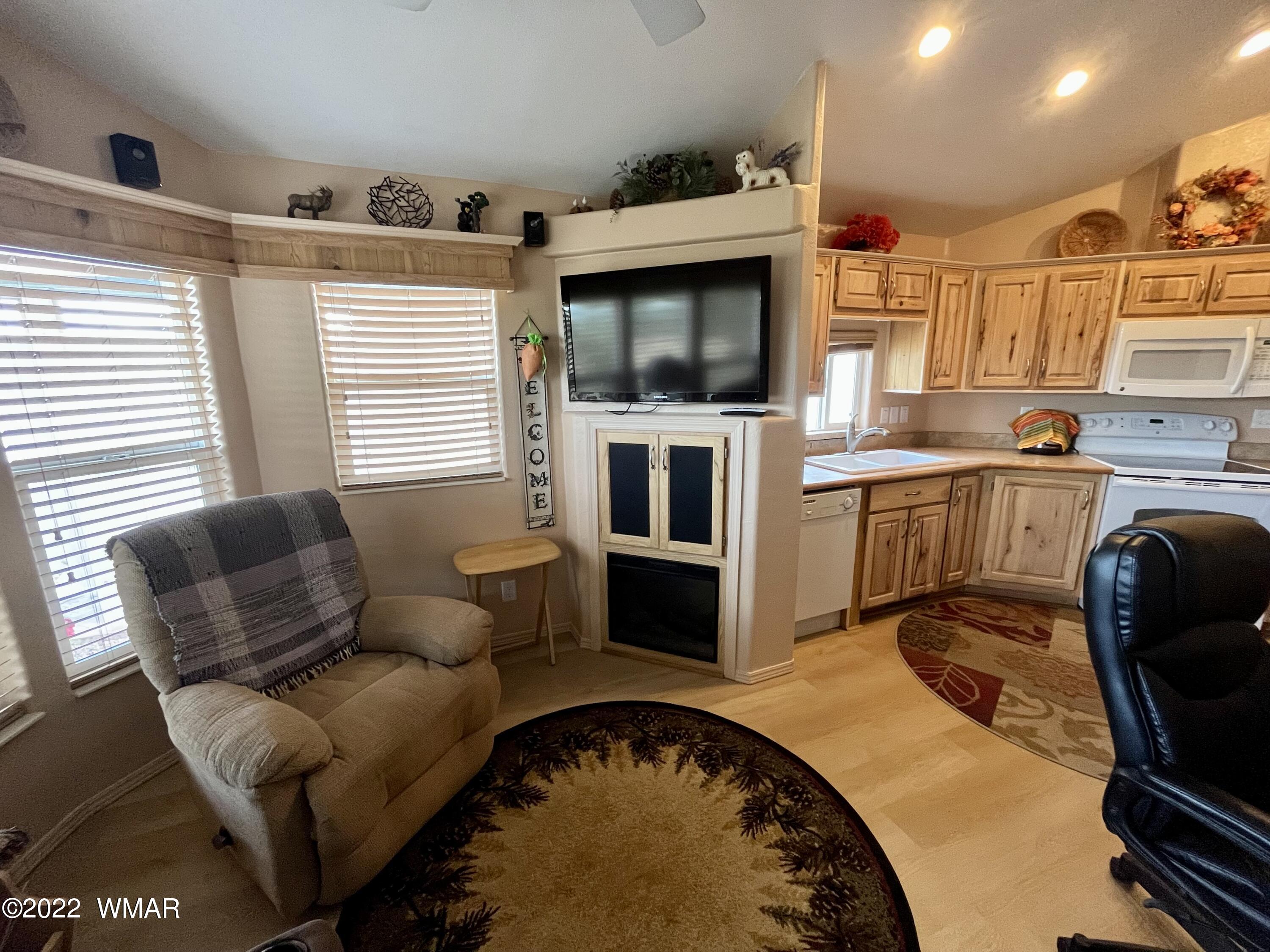 1860 Reel Way, Unit 471 Show Low, AZ 85901 - Photo 9 of 28 a living room with furniture and a flat screen tv