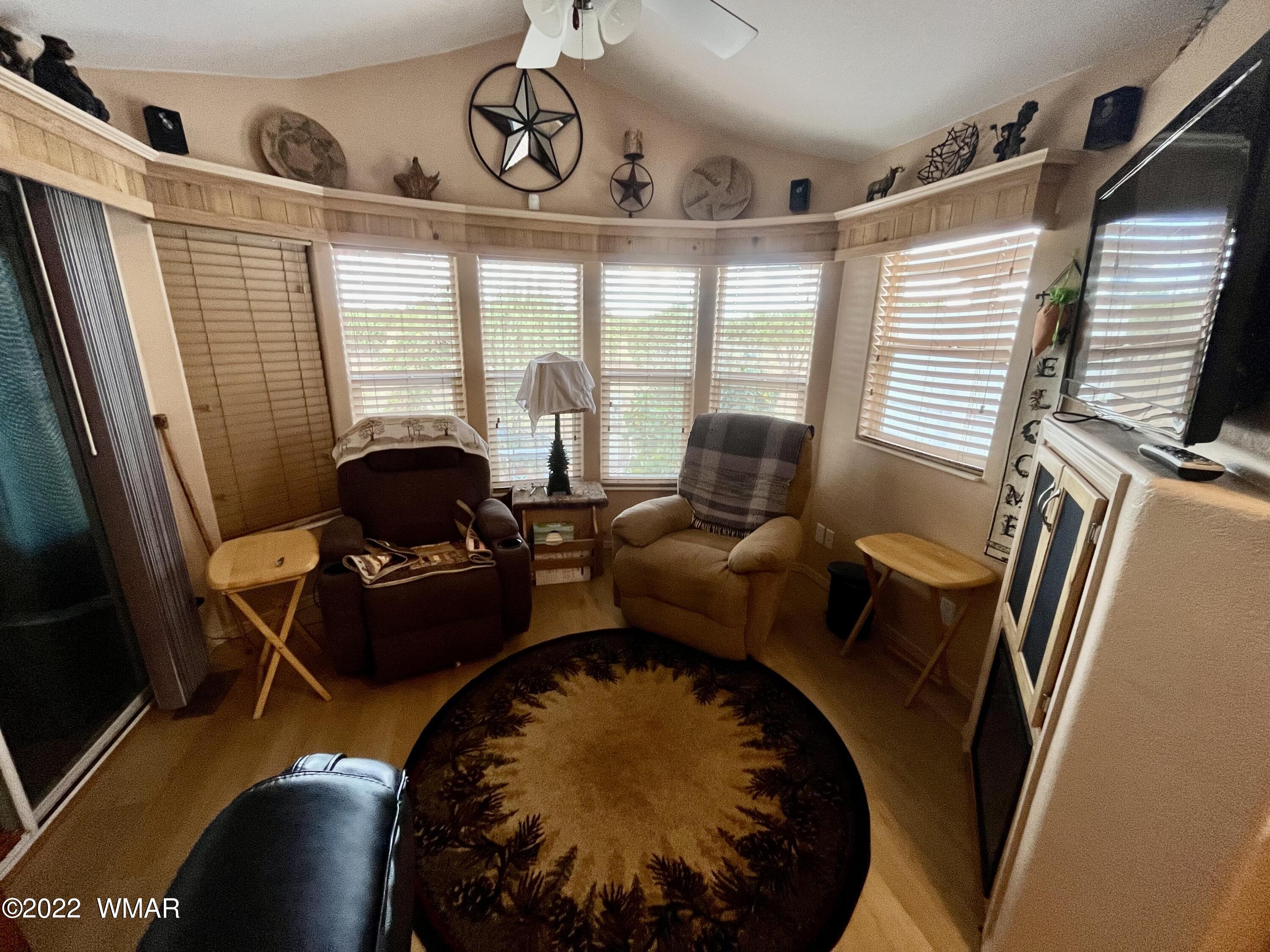 1860 Reel Way, Unit 471 Show Low, AZ 85901 - Photo 10 of 28 a living room with furniture and a floor to ceiling window