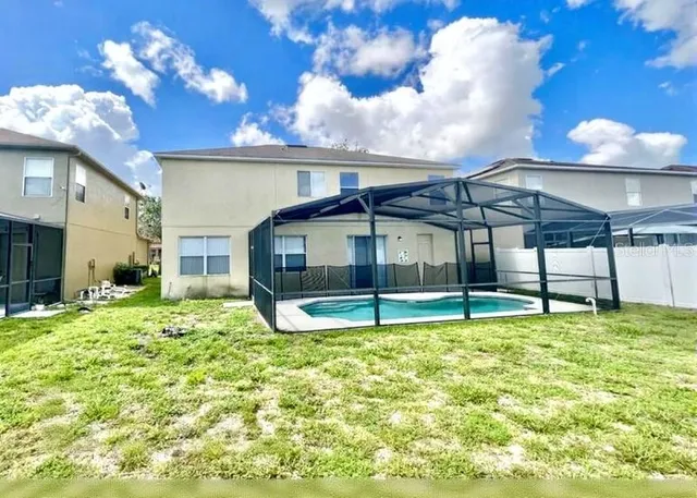a swimming pool with an outdoor seating and yard