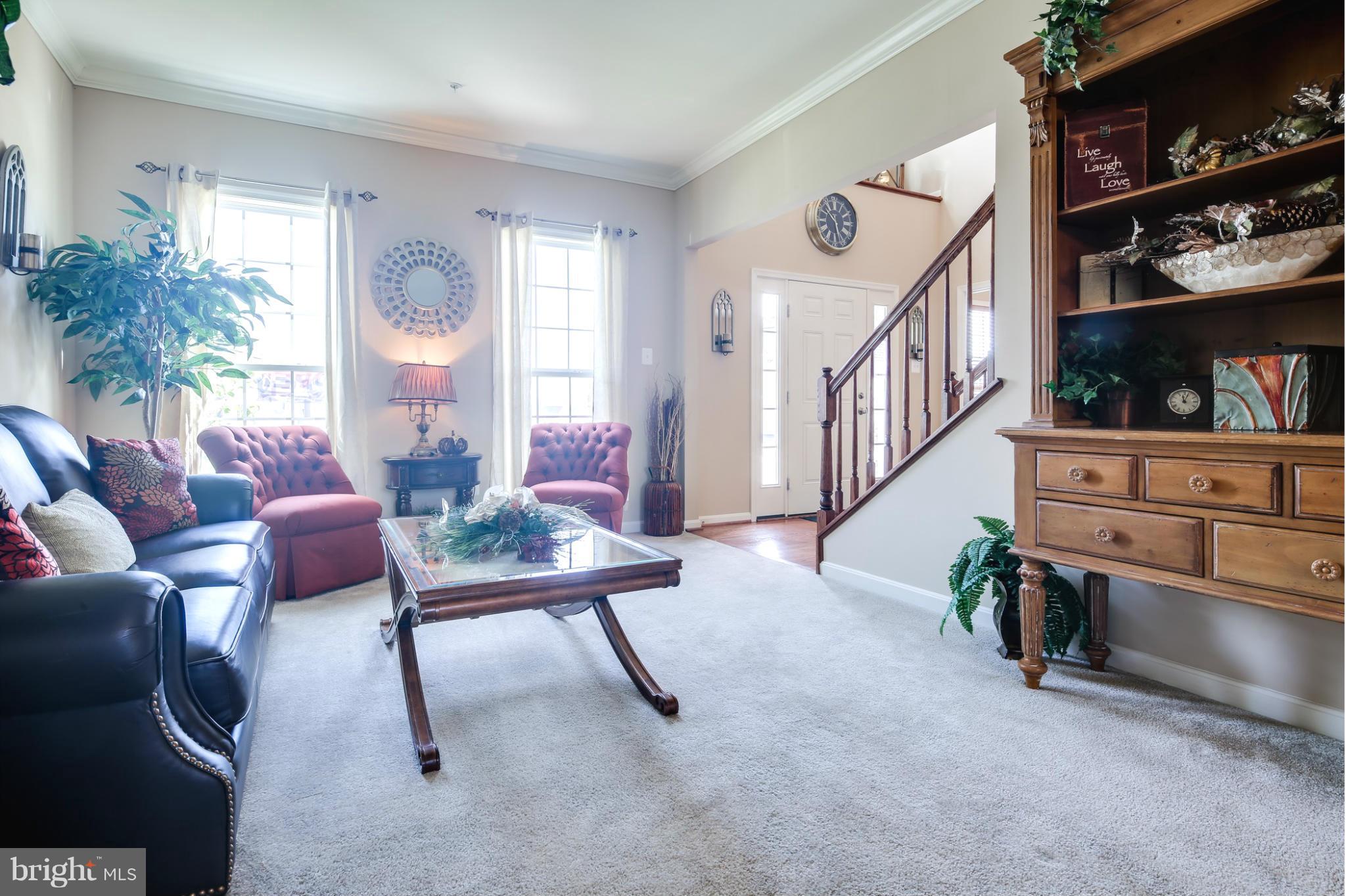 5920 Cypress Springs Road Elkridge, MD 21075 - Photo 12 of 28 a living room with furniture and a book shelf